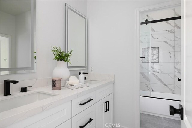 full bathroom featuring a sink, enclosed tub / shower combo, and double vanity