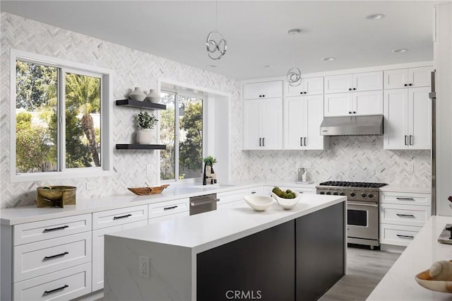 kitchen featuring open shelves, light countertops, white cabinets, under cabinet range hood, and appliances with stainless steel finishes