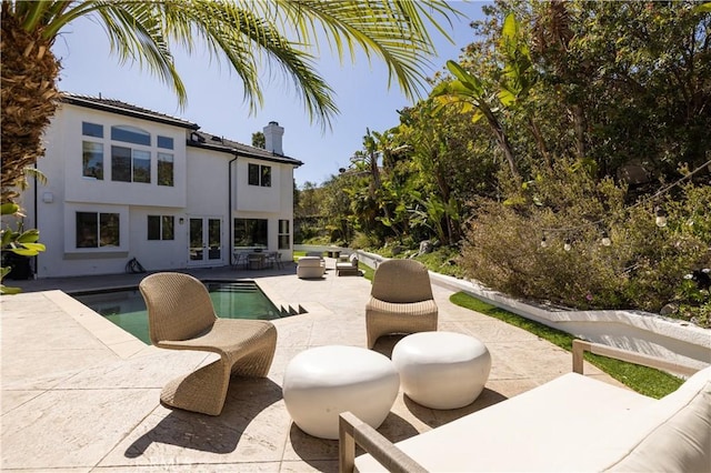 exterior space with an outdoor living space, french doors, and a patio area