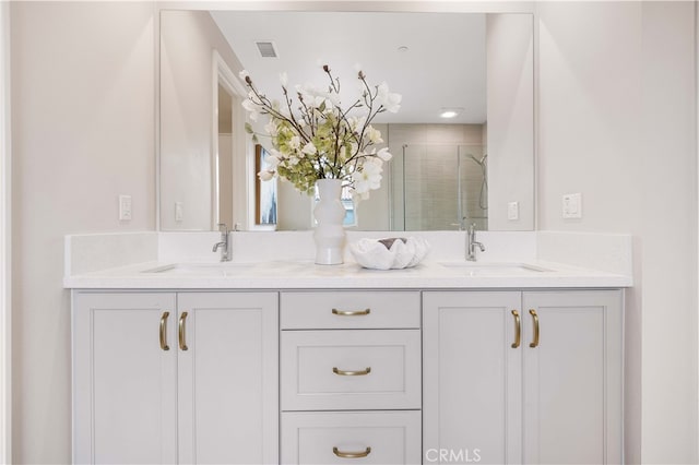 full bathroom featuring a sink, visible vents, a stall shower, and double vanity