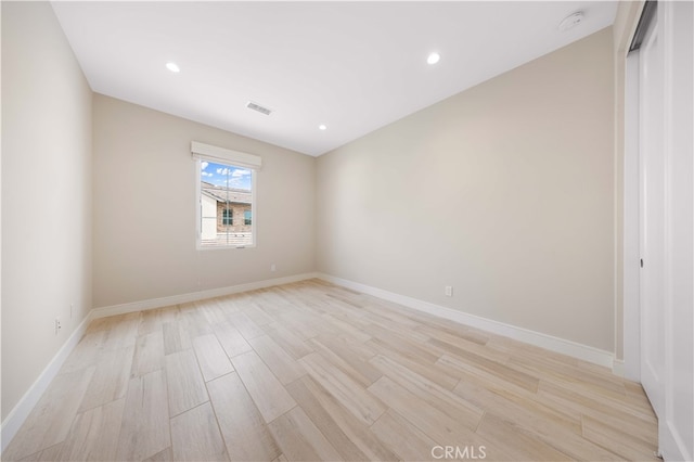 unfurnished room featuring recessed lighting, visible vents, baseboards, and light wood finished floors