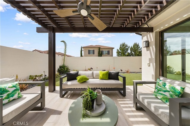 exterior space featuring an outdoor living space and ceiling fan