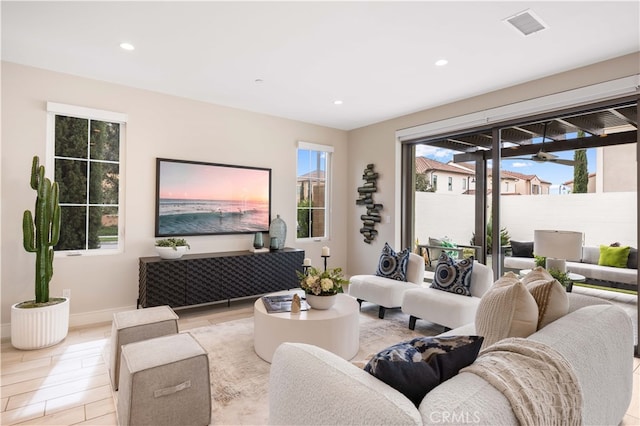 living area featuring recessed lighting, visible vents, baseboards, and light wood-style flooring