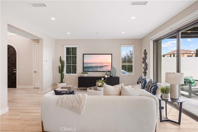 living room featuring visible vents, recessed lighting, light wood-style floors, and baseboards