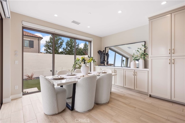 dining space with baseboards, recessed lighting, visible vents, and light wood-type flooring