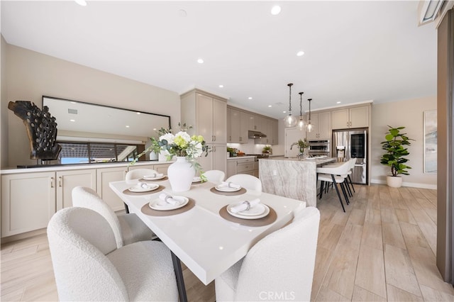 dining space featuring recessed lighting, baseboards, and light wood finished floors