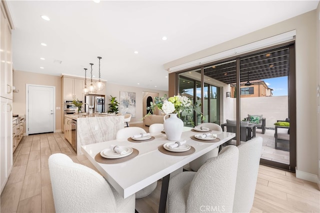 dining area featuring a notable chandelier, recessed lighting, light wood-type flooring, and baseboards