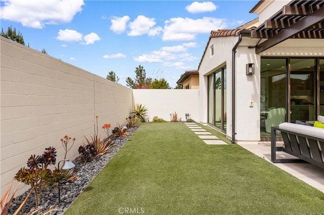 view of yard featuring a patio area and a fenced backyard