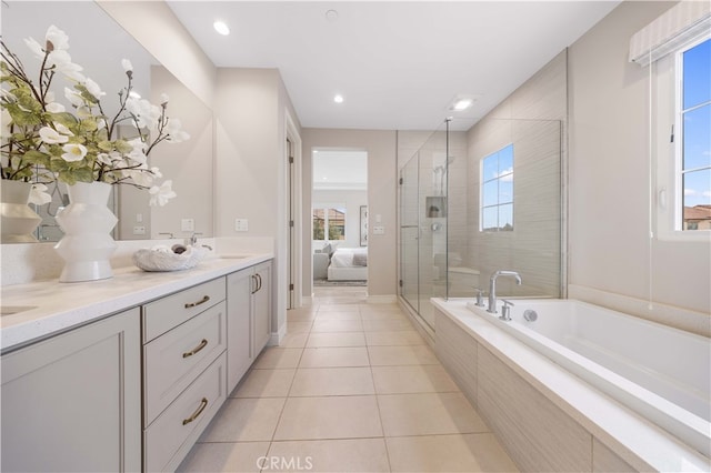 ensuite bathroom featuring tile patterned flooring, a shower stall, a garden tub, and a healthy amount of sunlight