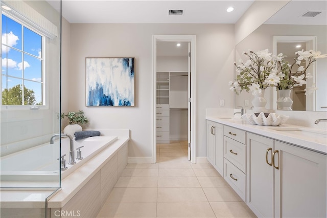 full bath with a sink, visible vents, a garden tub, and tile patterned flooring