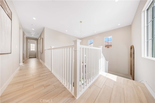 corridor with visible vents, recessed lighting, baseboards, and wood finished floors