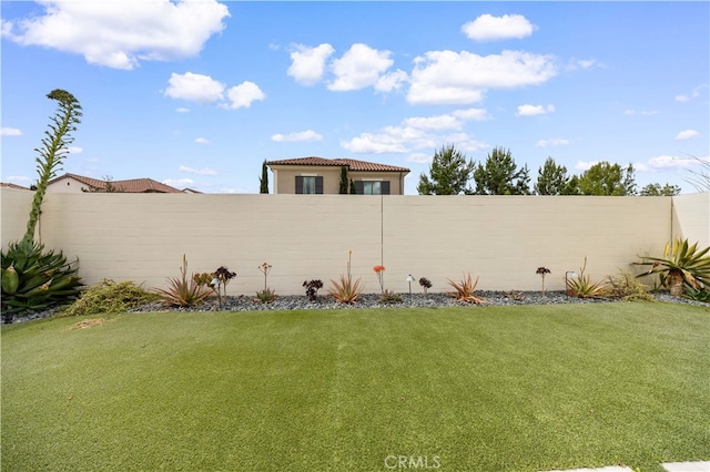 view of yard with a fenced backyard