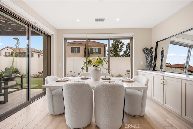 dining area with recessed lighting, visible vents, and light wood finished floors