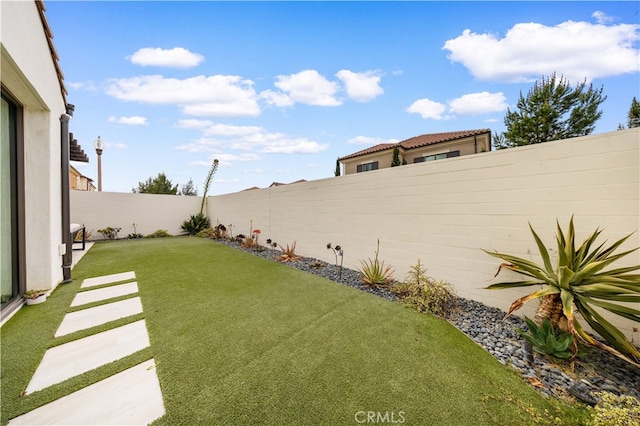 view of yard with a fenced backyard