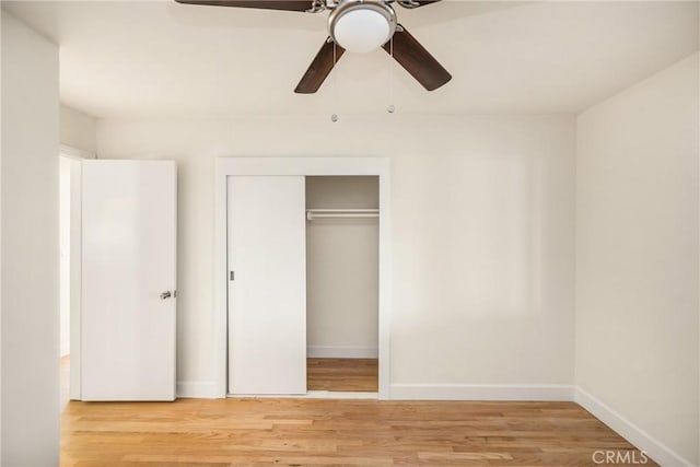 unfurnished bedroom featuring a ceiling fan, light wood-style floors, a closet, and baseboards