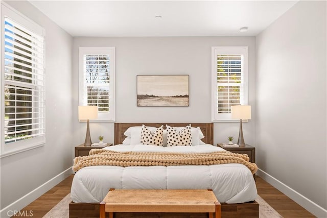 bedroom with wood finished floors and baseboards