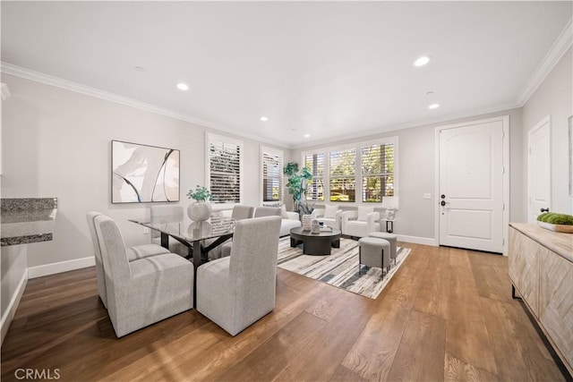 dining room with recessed lighting, baseboards, wood finished floors, and crown molding