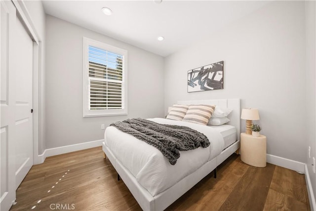 bedroom featuring recessed lighting, wood finished floors, and baseboards