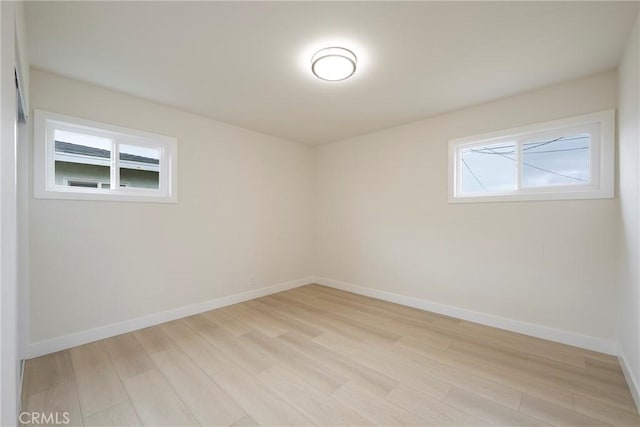 unfurnished room featuring light wood-type flooring and baseboards