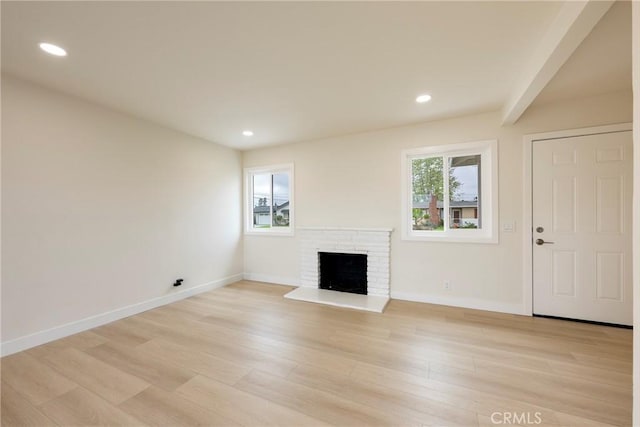 unfurnished living room featuring recessed lighting, baseboards, and light wood-type flooring