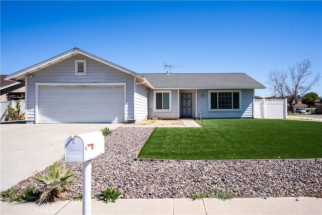 single story home with a front lawn, an attached garage, fence, and driveway