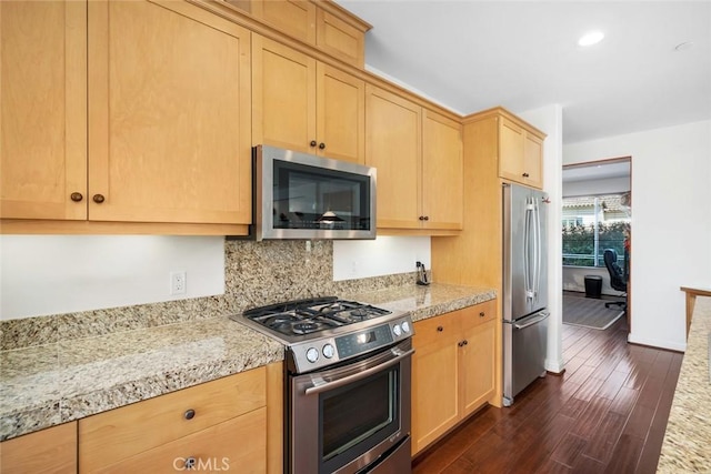 kitchen with light brown cabinets, dark wood-style floors, stainless steel appliances, decorative backsplash, and baseboards