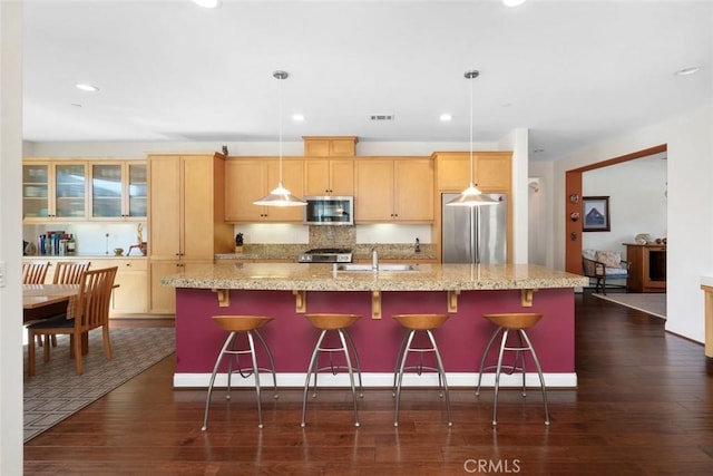 kitchen featuring dark wood-style floors, visible vents, appliances with stainless steel finishes, and a sink