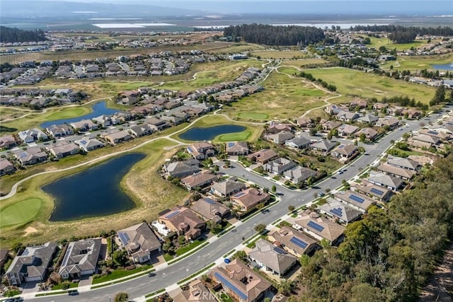 bird's eye view with golf course view, a water view, and a residential view