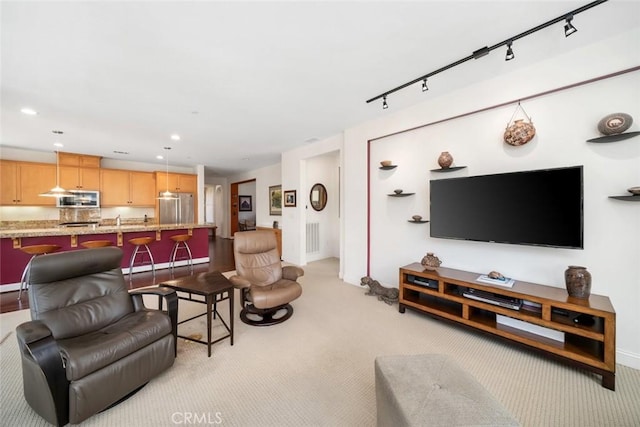 living area featuring recessed lighting, visible vents, light carpet, and track lighting