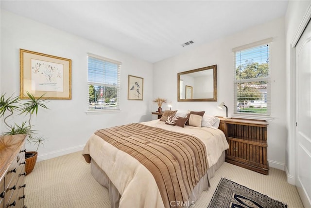 bedroom with a closet, visible vents, baseboards, and carpet floors