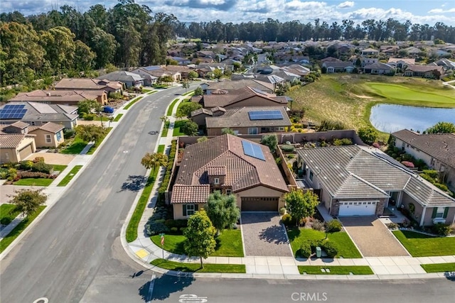 drone / aerial view featuring a residential view and a water view