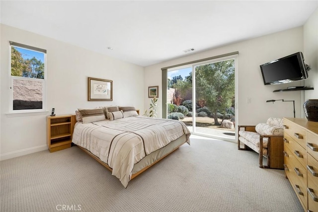 bedroom featuring access to exterior, light colored carpet, baseboards, and visible vents