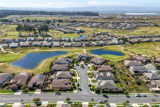 bird's eye view with a residential view, a water view, and golf course view