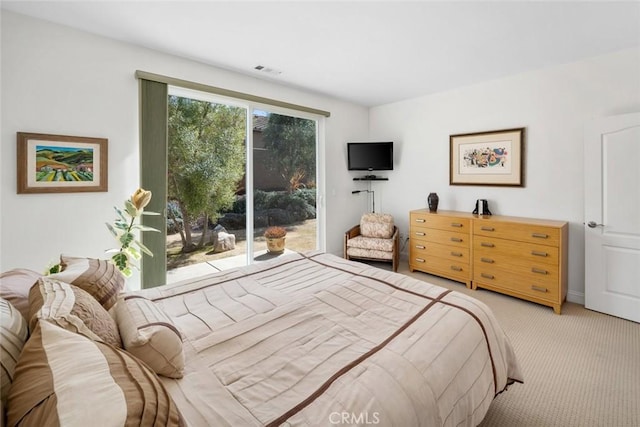 bedroom featuring light carpet, visible vents, and access to outside