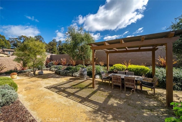 view of patio featuring outdoor dining area, fence, and a pergola