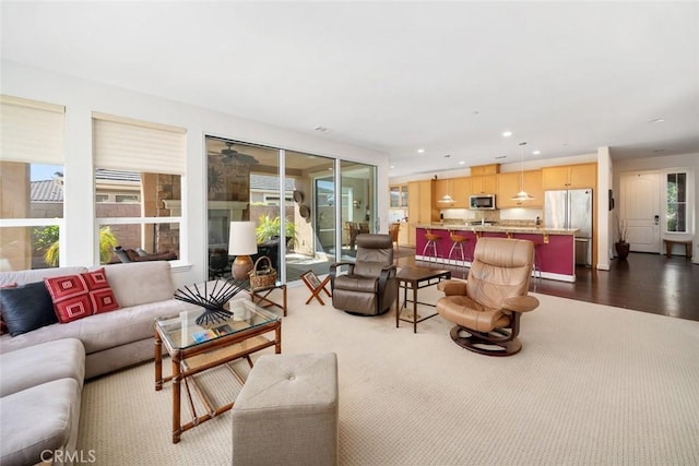 living area with recessed lighting and dark wood-style flooring