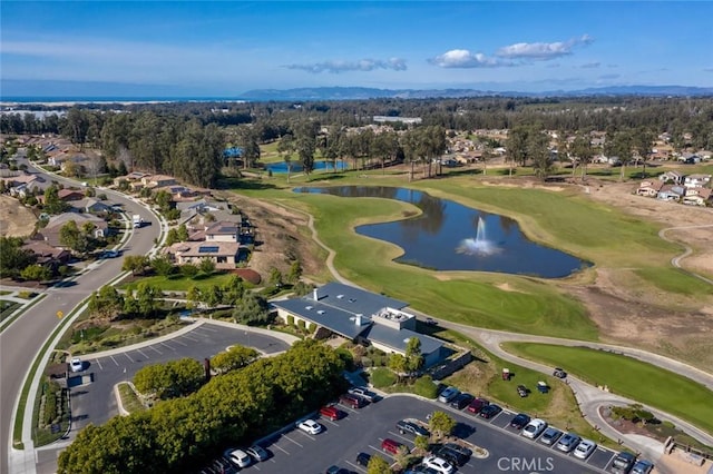 birds eye view of property featuring golf course view and a water view