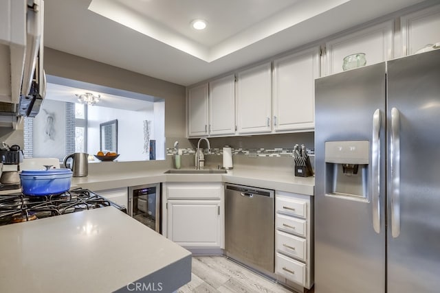 27578 Lene, Mission Viejo, CA 92692 - kitchen featuring appliances with stainless steel finishes, a sink, light countertops, white cabinets, and light wood-style floors