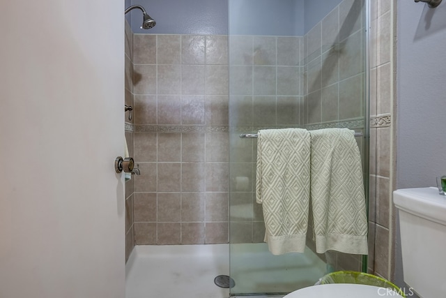 full bath featuring toilet and a stall shower