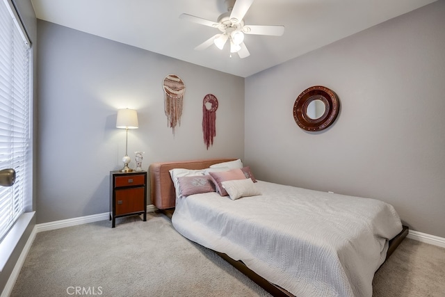 bedroom with baseboards, light colored carpet, and a ceiling fan