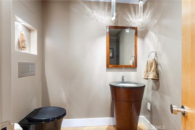 bathroom with baseboards and vanity