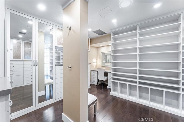 walk in closet featuring visible vents, hardwood / wood-style floors, and french doors