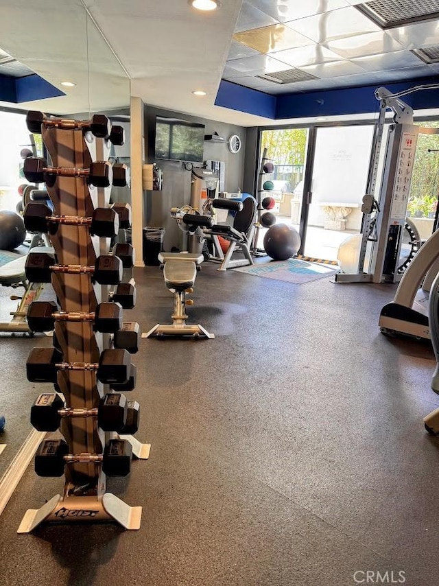 workout area featuring visible vents and a paneled ceiling