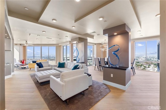 living area featuring visible vents, baseboards, and light wood-type flooring