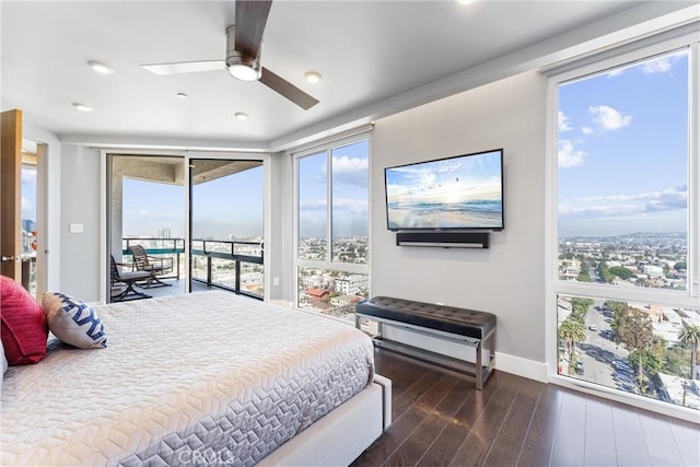 bedroom featuring a ceiling fan, access to exterior, wood finished floors, and baseboards