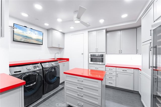 washroom with cabinet space, recessed lighting, a ceiling fan, and washing machine and clothes dryer