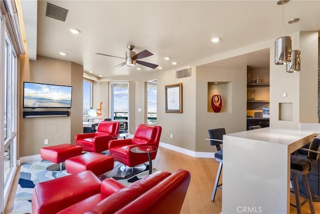 home theater featuring recessed lighting, visible vents, baseboards, and light wood-style flooring