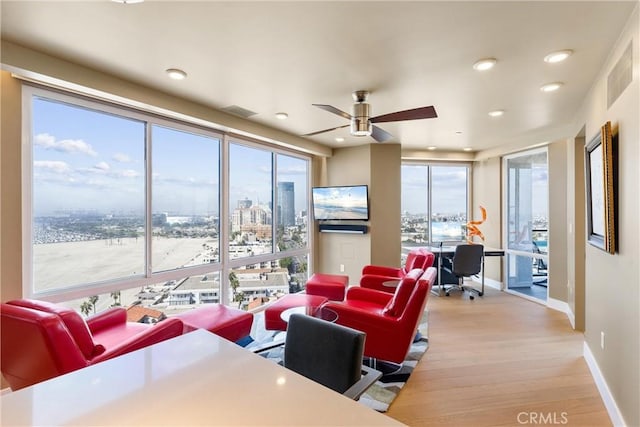 living area featuring recessed lighting, visible vents, baseboards, and light wood finished floors