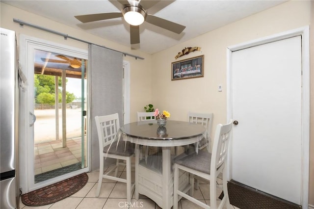 dining room featuring light tile patterned floors and ceiling fan