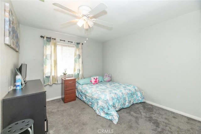 carpeted bedroom featuring baseboards and a ceiling fan